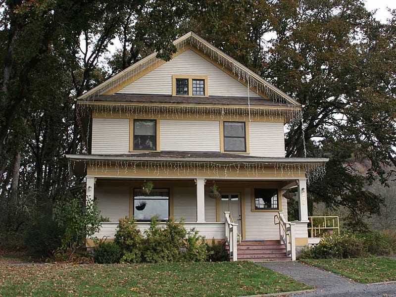 Two-story house with icicles hanging from the roof eaves