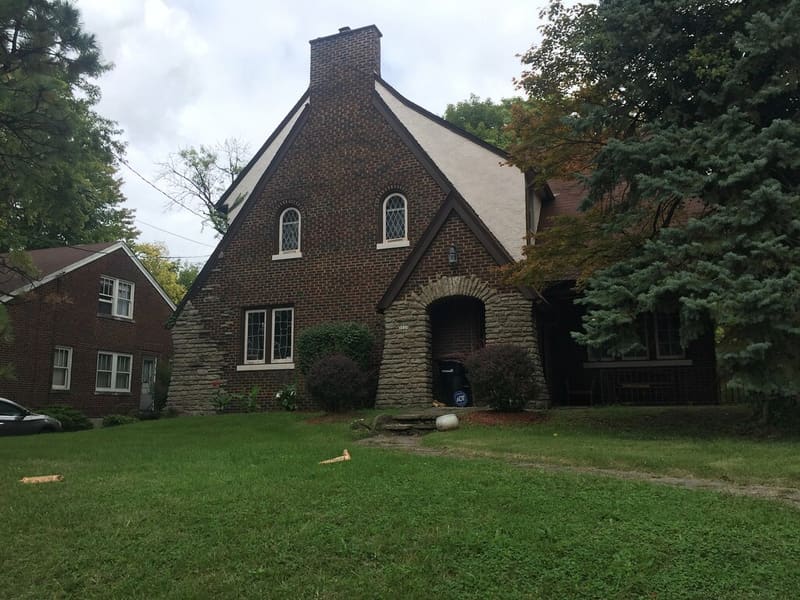 Residential home exterior with siding, brick, and roof planes